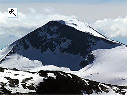 Store Rauddalstind is the highest and almost central point on a long ridge which contains three mountains, here seen from the north