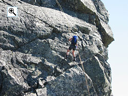 
The 4 metre grade V slab on the upper crag on the West Ridge of Midtre Torfinnstind is just above the abseiler