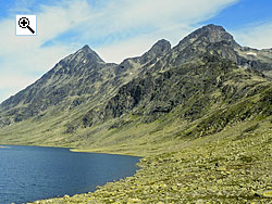 From the left Knutsholstind, Vesle Knutsholstind and Vestre Leirungstind soar above the lakes in Svartdalen valley