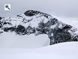 When viewed from Nautgardsoksle the awesome north face of Nautgardstind rises steeply from the glacier in the corrie